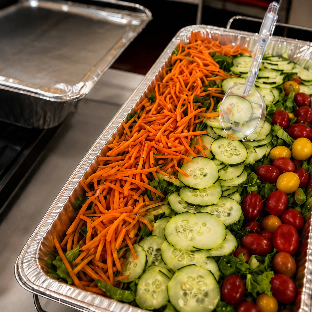 Fresh catering salad with cucumber, carrots, and cherry tomatoes